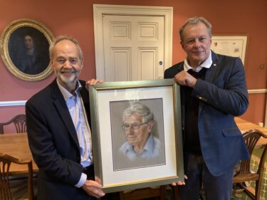 Gary King presents a portrait of his father, Richard King, to the Master