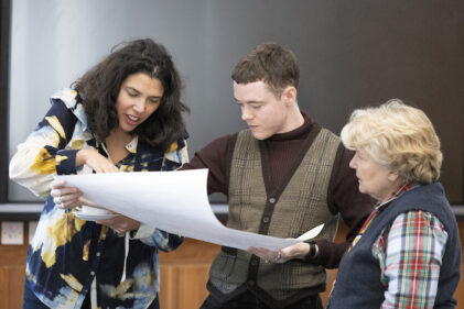 Sandi Toksvig viewing a map with students and Fellows